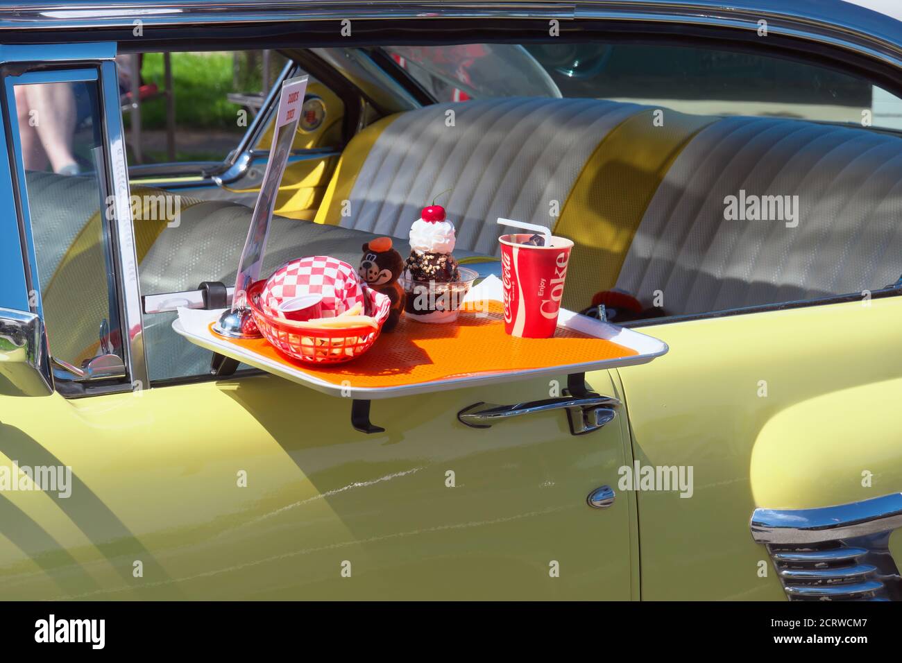 Vintage yellow 2 door Mercury hardtop (`56 Mercury?) with take-out food tray at a car show in Maple Ridge, B. C., Canada, May 2019. Stock Photo